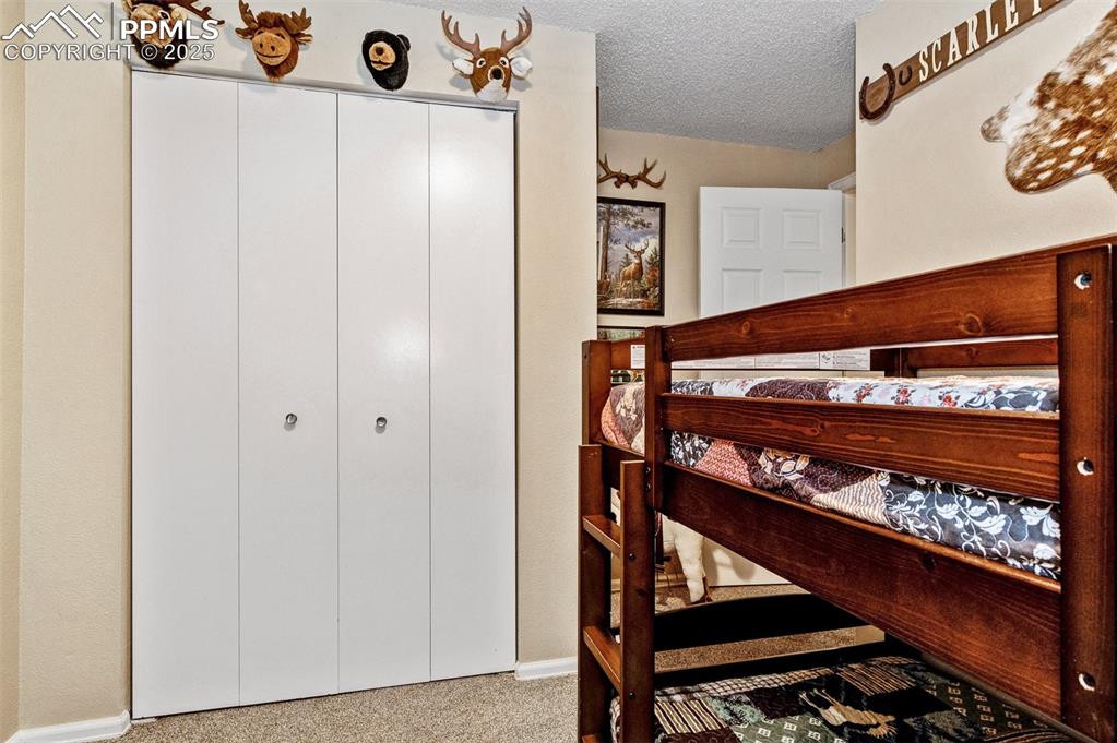 Bedroom with carpet flooring and a textured ceiling