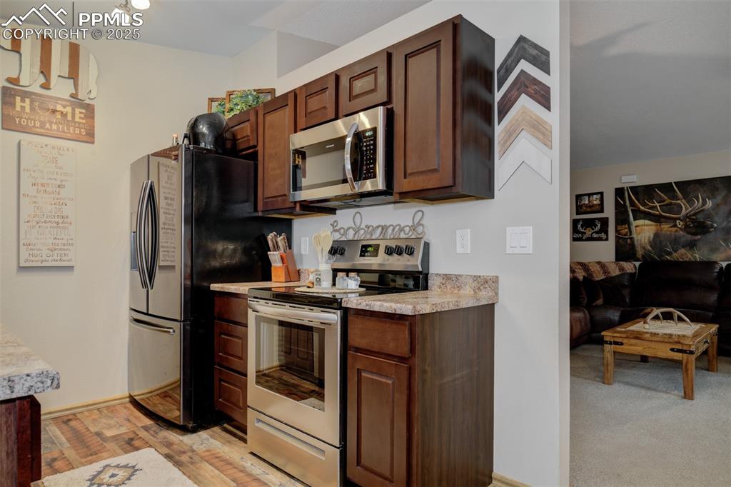 Kitchen featuring newwer appliances with stainless steel finishes