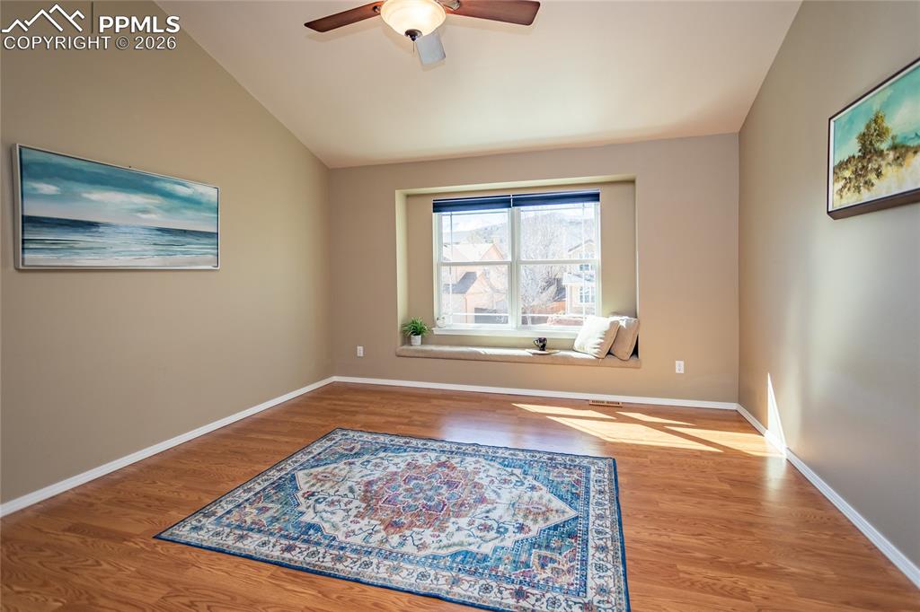 Master bedroom with gleaming laminate flooring.