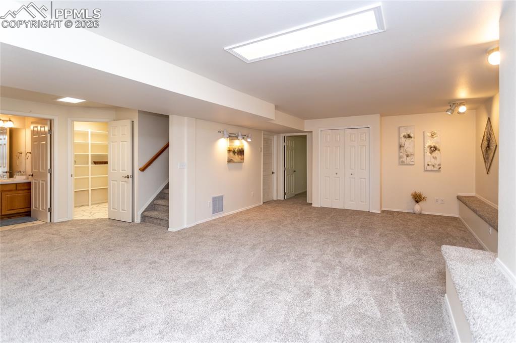 The garden level basement is light & bright with a huge rec room..
