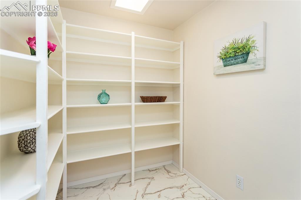 This huge pantry has marble-look LVP floors and tons of storage!