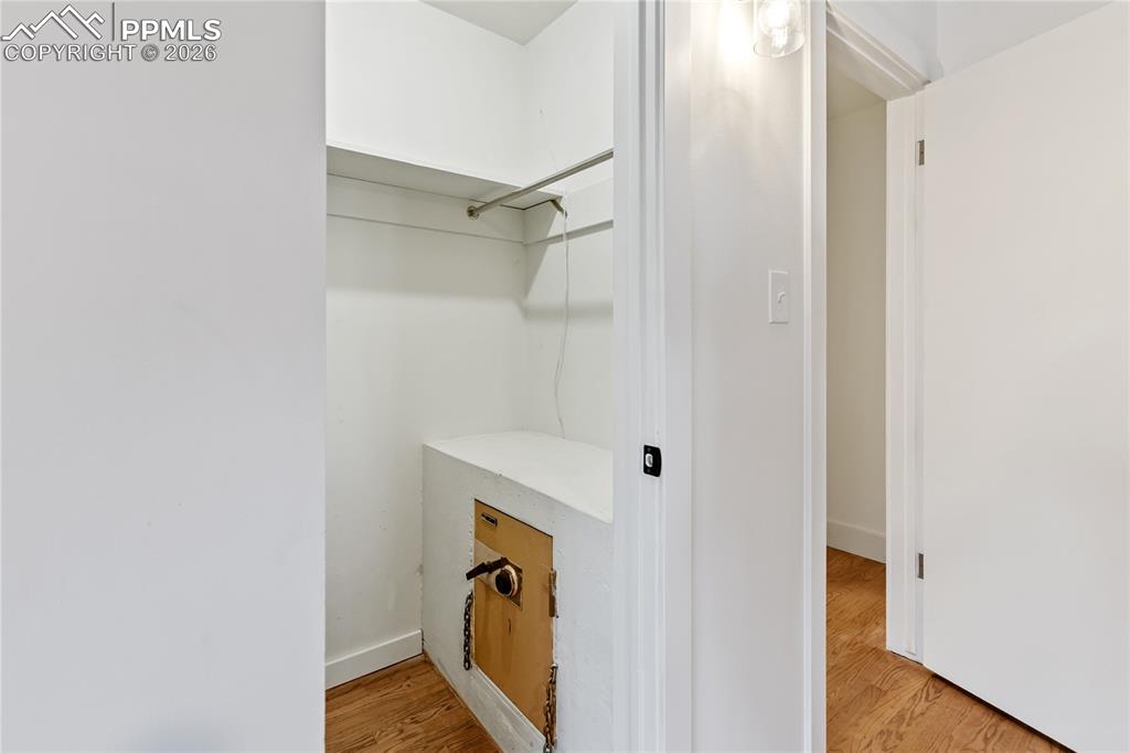Primary bedroom features walk-in closet complete with a built-in safe.