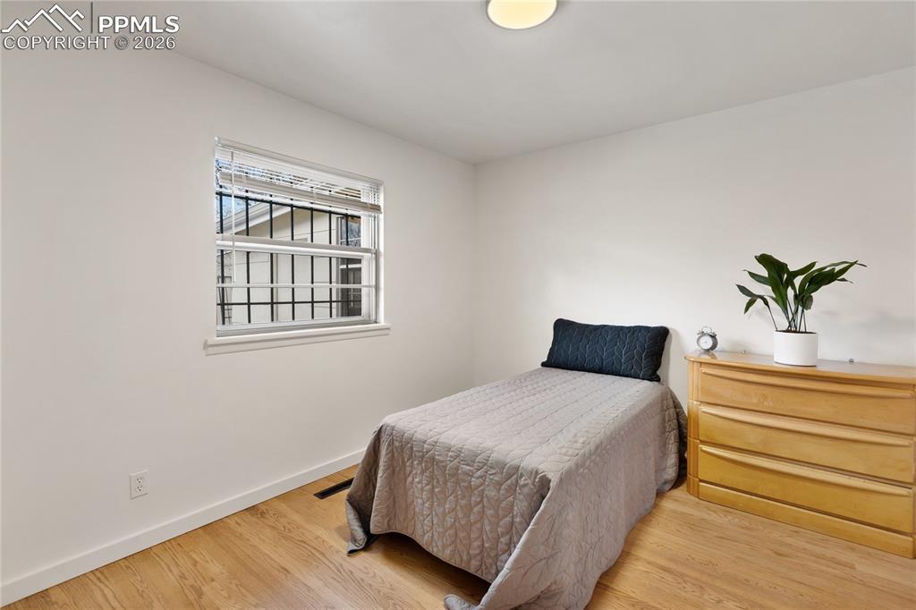 One of 3 bedrooms on the main level.  Refinished hardwood flooring, new doors/hardware.