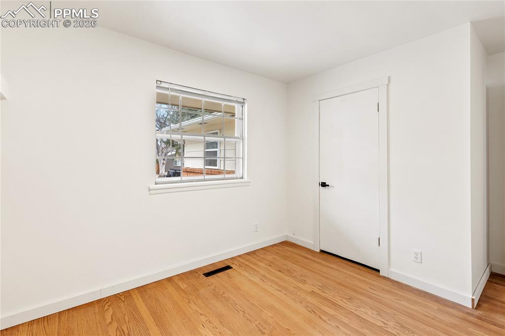 One of 3 bedrooms on the main level.  Refinished hardwood flooring, new doors/hardware.
