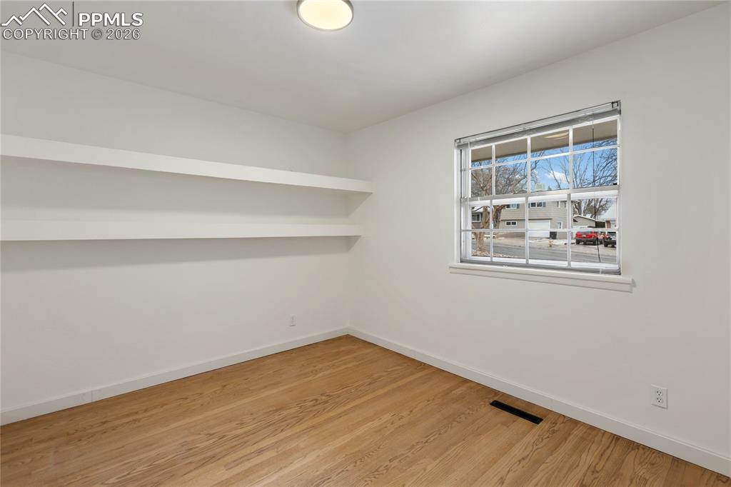 One of 3 bedrooms on the main level.  Refinished hardwood flooring, new doors/hardware.