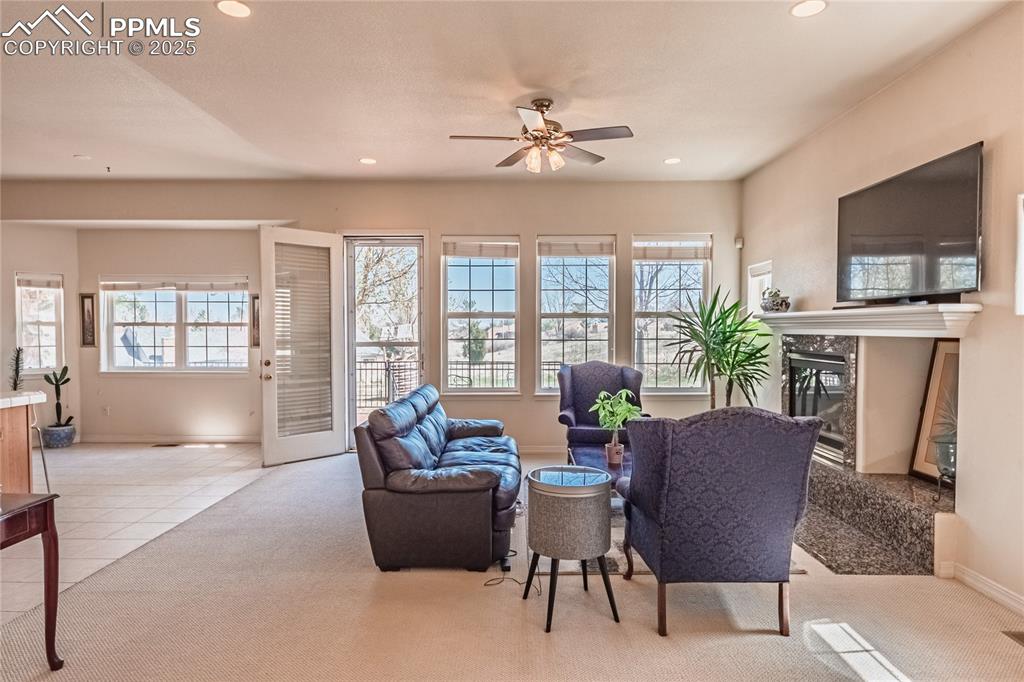 Living area featuring recessed lighting, a high end fireplace, baseboards, and ceiling fan