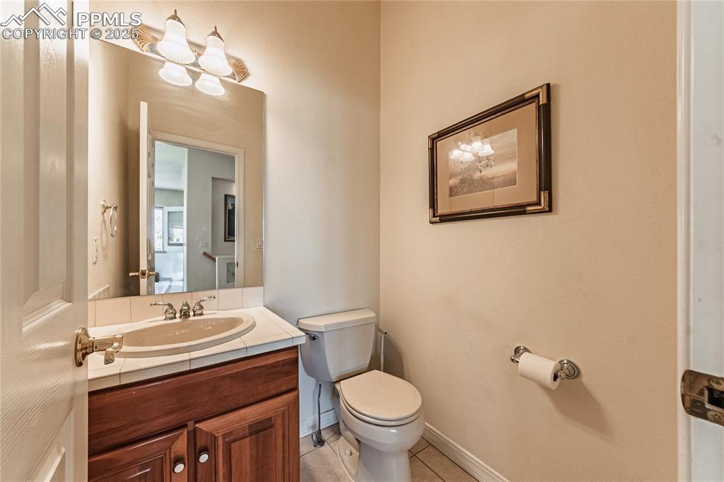 Bathroom with tile patterned floors, toilet, and vanity