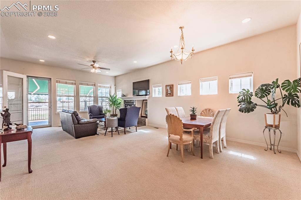 Dining area with recessed lighting and light colored carpet