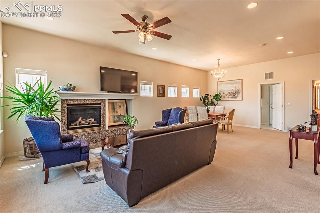 Living room with visible vents, recessed lighting, and light colored carpet