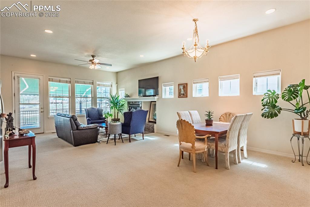 Dining area featuring light colored carpet and recessed lighting