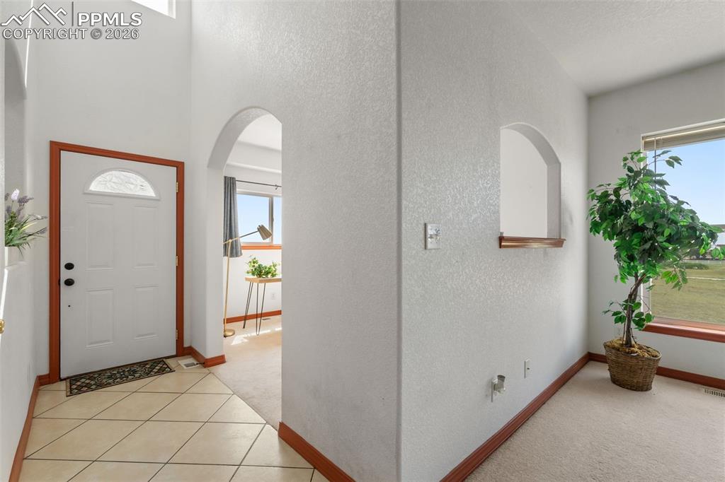 Front door opens to vaulted ceiling