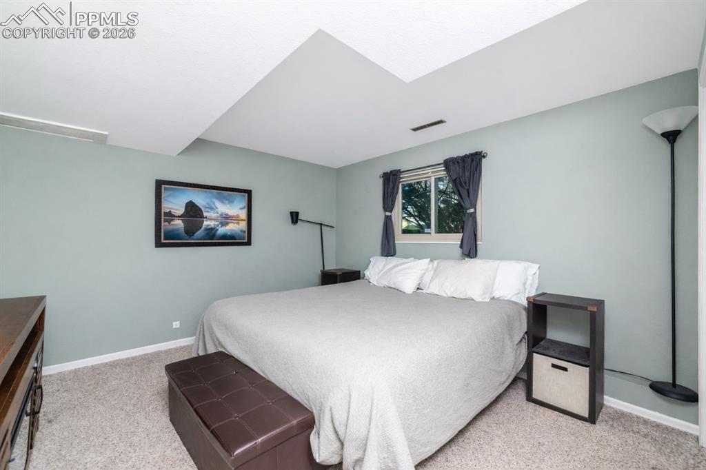 Bedroom featuring light colored carpet and baseboards