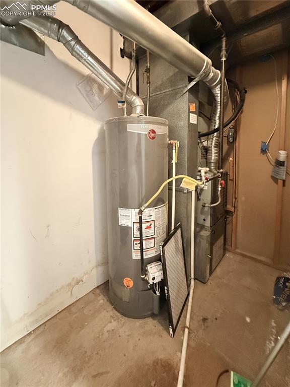 Utility room with water heater and heating unit