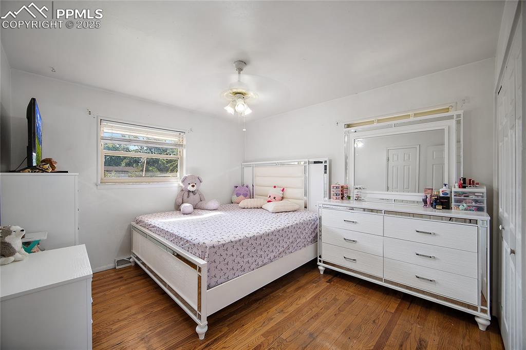 Bedroom featuring dark wood-style flooring and ceiling fan