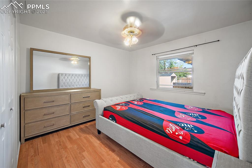 Bedroom with light wood finished floors and ceiling fan