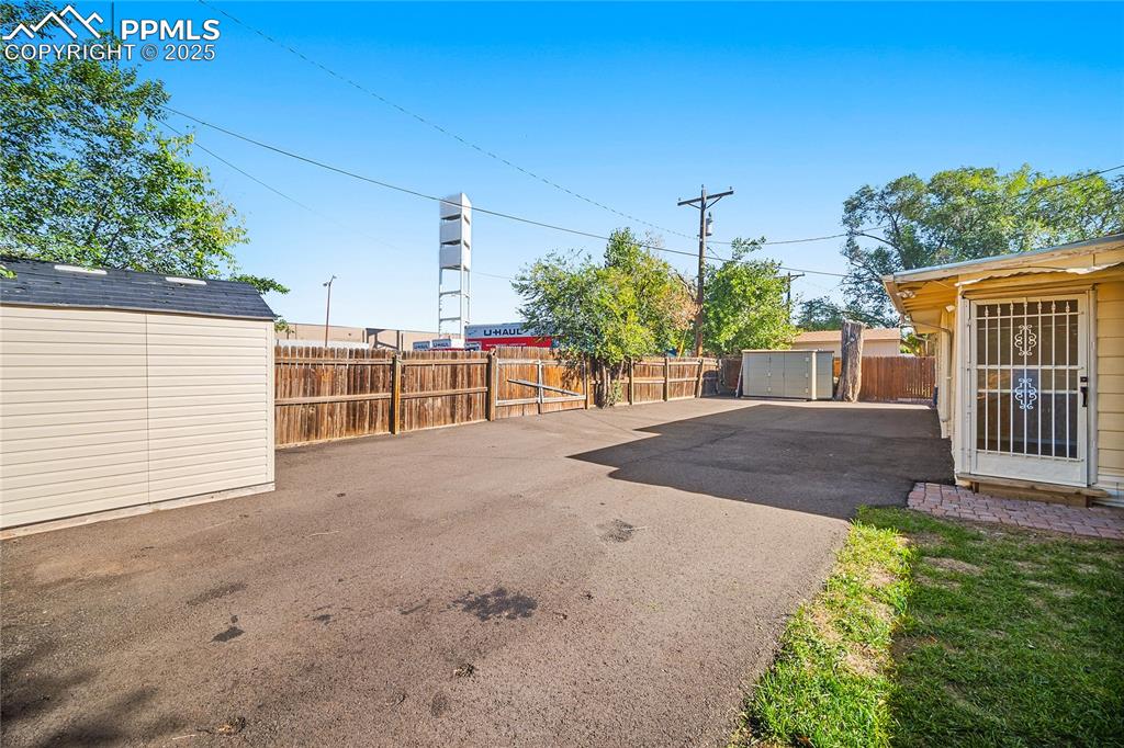 View of patio featuring a storage unit