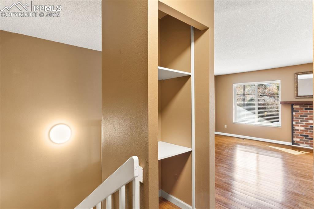 Entry from upper level door with built-in shelving for storage and access to lower level