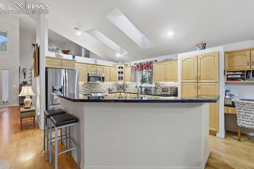 Huge kitchen with expansive granite countertops, high-end appliances.