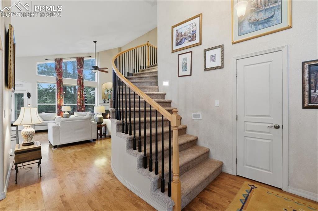 Spiral staircase to upper level off of entryway