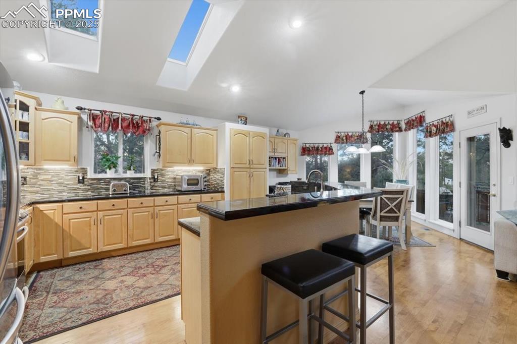 Huge kitchen with expansive granite countertops, high-end appliances.