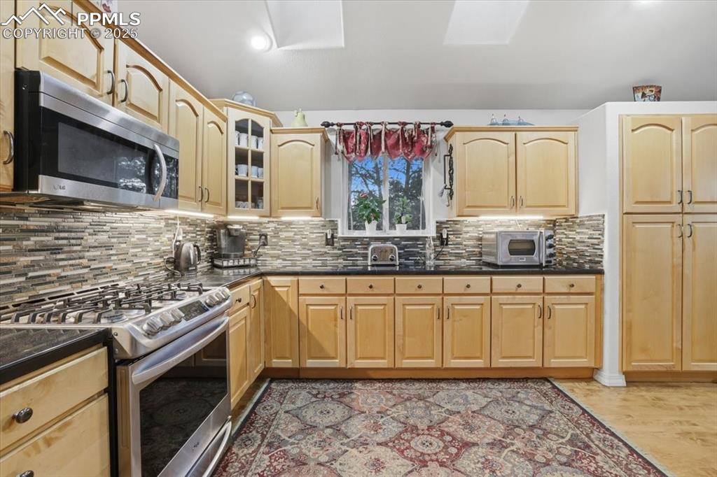 HUGE kitchen with expansive granite countertops, high-end appliances.