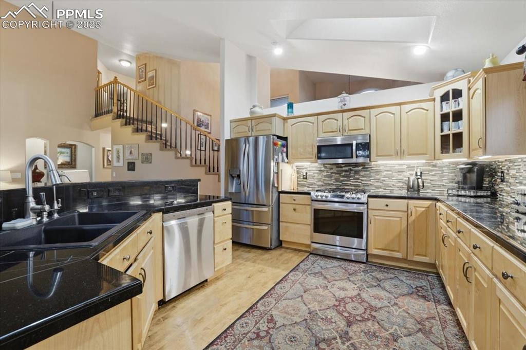 HUGE kitchen with expansive granite countertops, high-end appliances.
