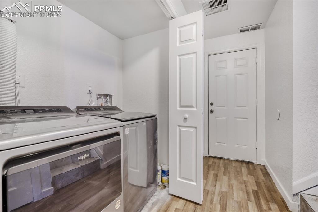 Lower level-Laundry Closet featuring washing machine and clothes dryer included