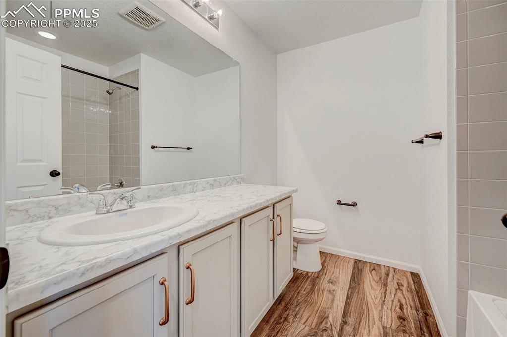 Bathroom featuring vanity and wood finished floors