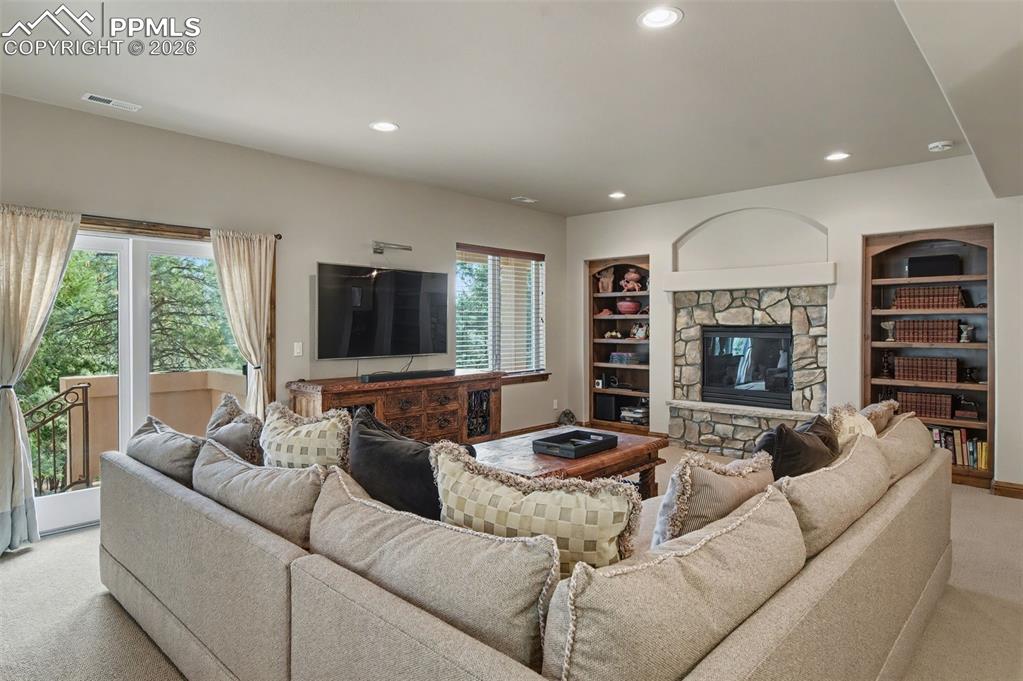 Built-in shelving and a second gas log fireplace make this another comfortable spot for time with friends and family.