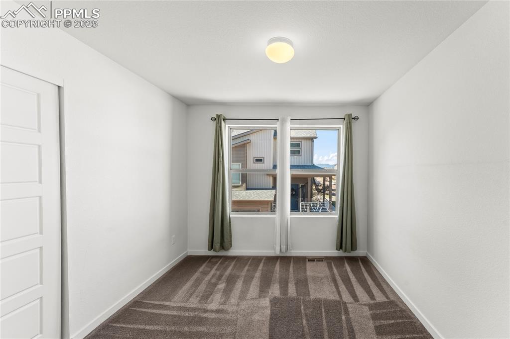 Spare room with dark carpet
