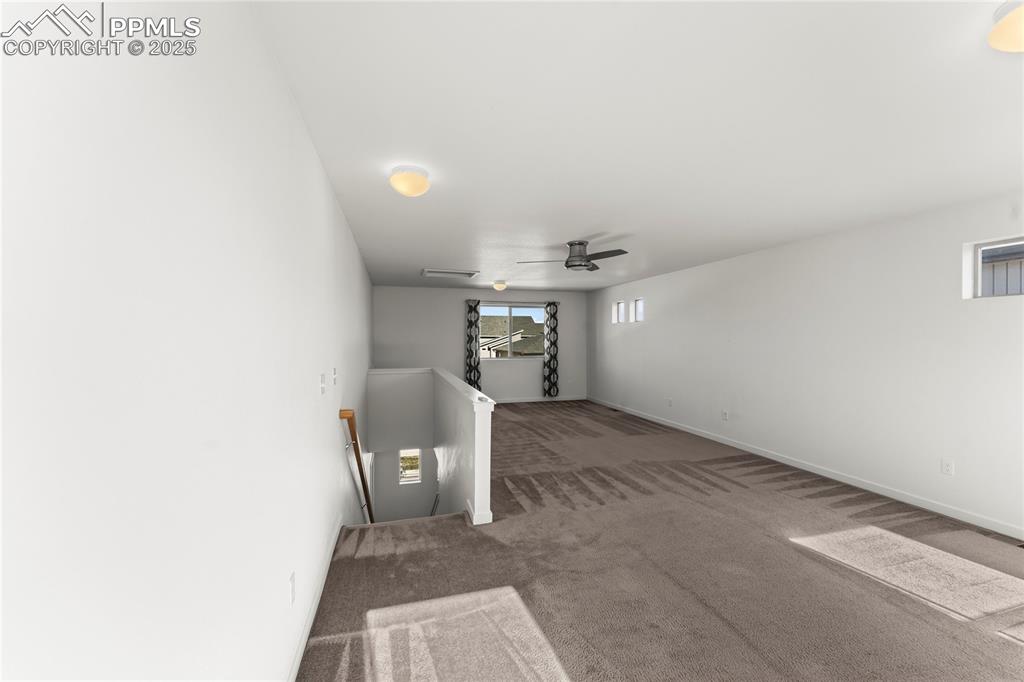 Empty room featuring carpet floors and baseboards