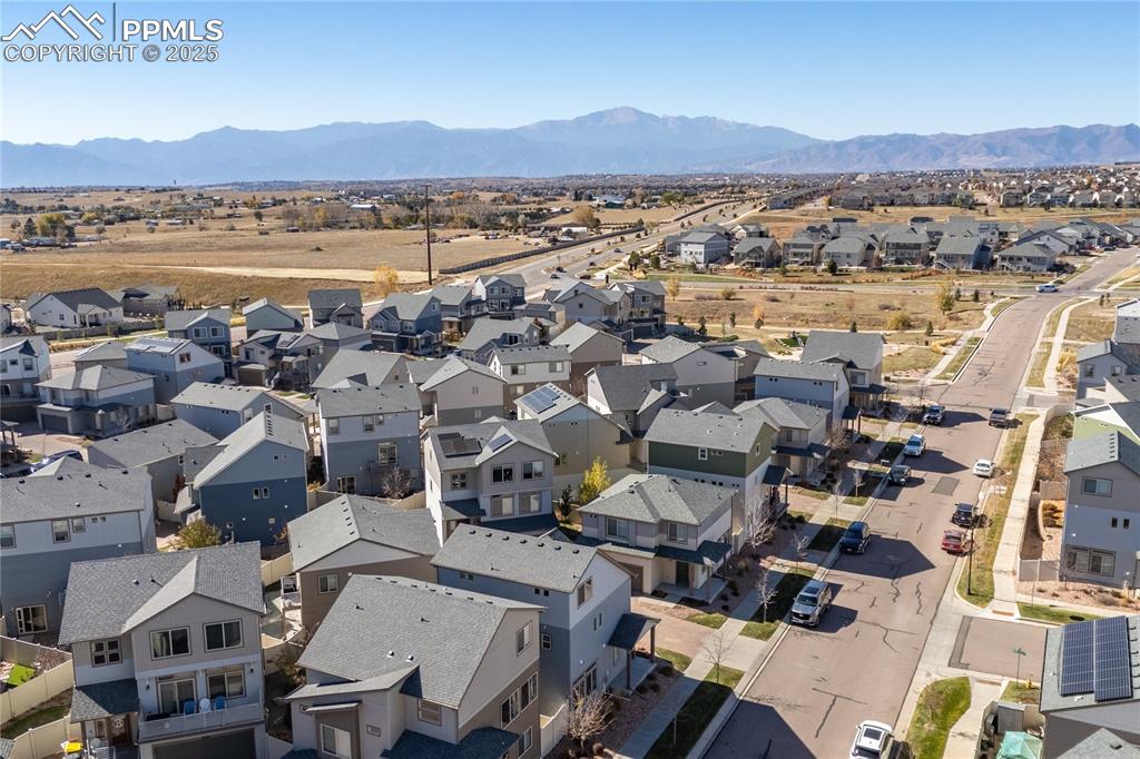 Aerial view of residential area featuring a mountainous background