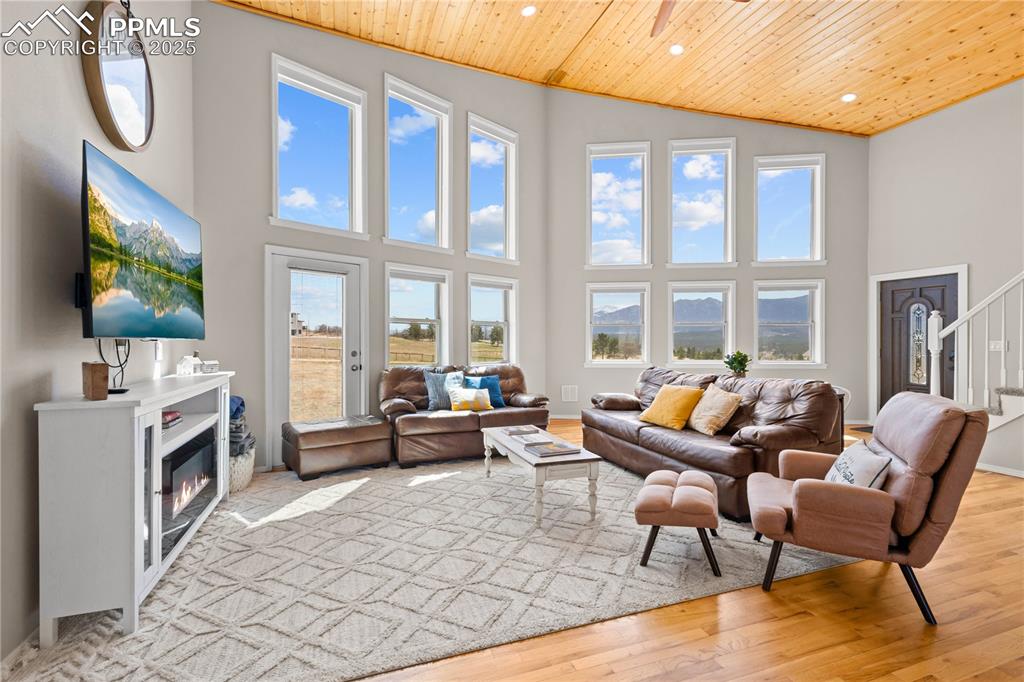 View from the dining space looking toward the front door showing the large windows with mountain views.