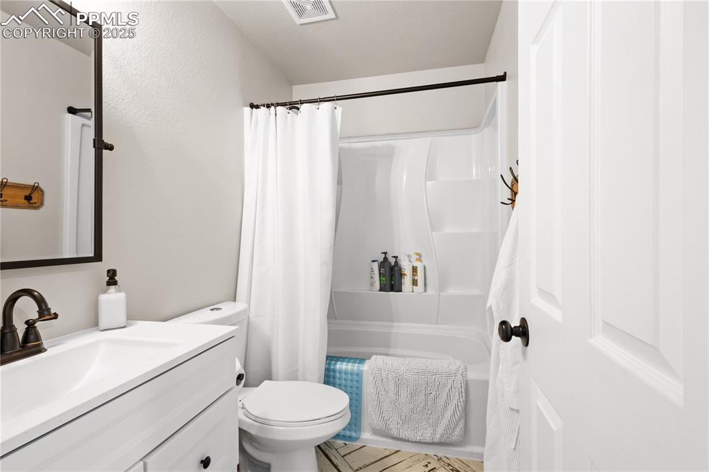 Recently added main level full bathroom with vanity, toilet, and shower/bath combo located next to the bonus room.