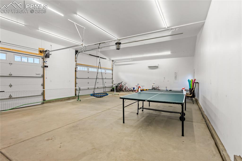 Four car garage has lots of lights and currently used for indoor fun at the short term rental. 