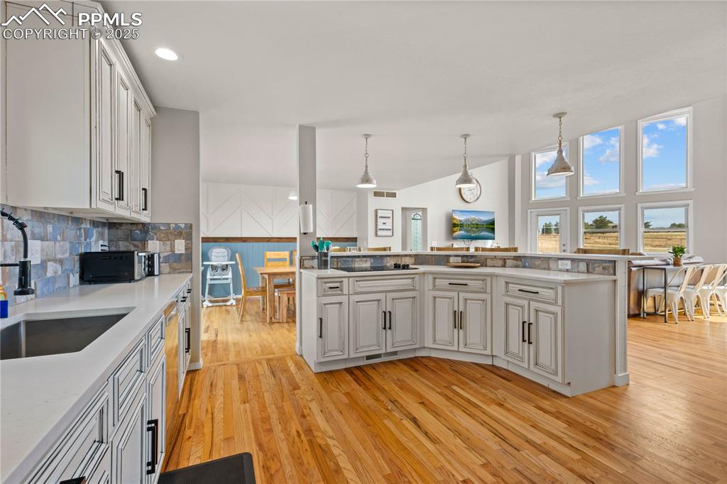 Kitchen has island with cook top and adds additional work space as well as seating.