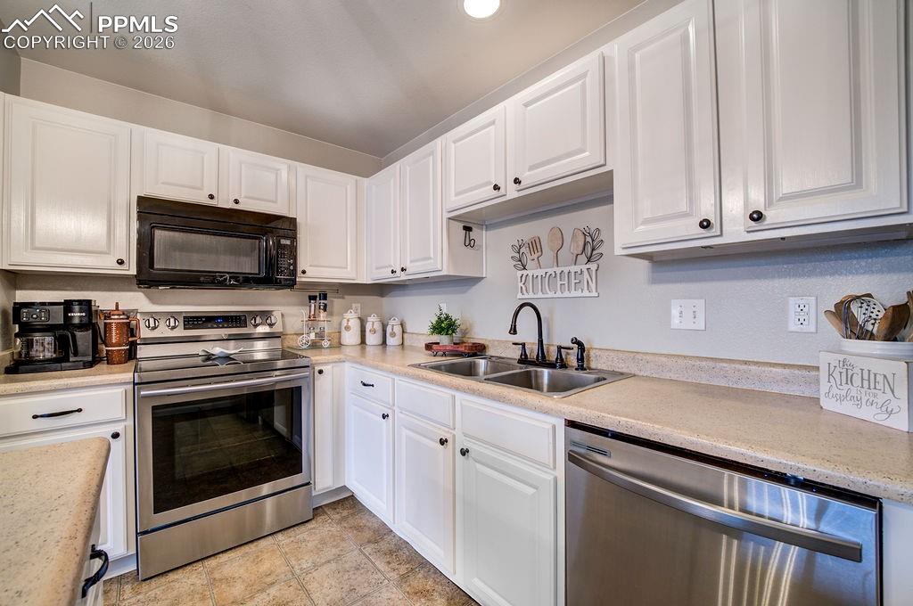 Stainless steel appliances include a smooth top range oven, built in microwave oven, dishwasher, and French Door refrigerator.