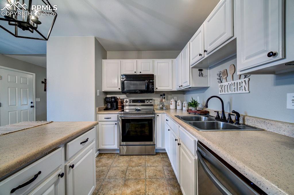 Abundant white cabinets for kitchen storage.