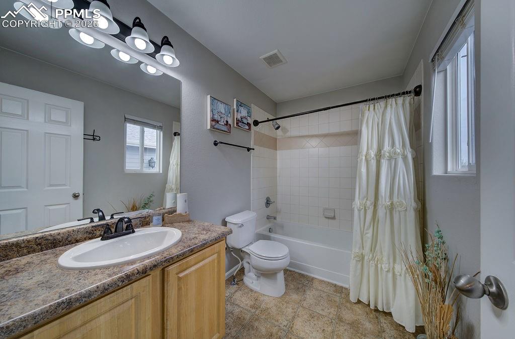 The Primary Bathroom offers a vanity, mirror, and tub/shower.