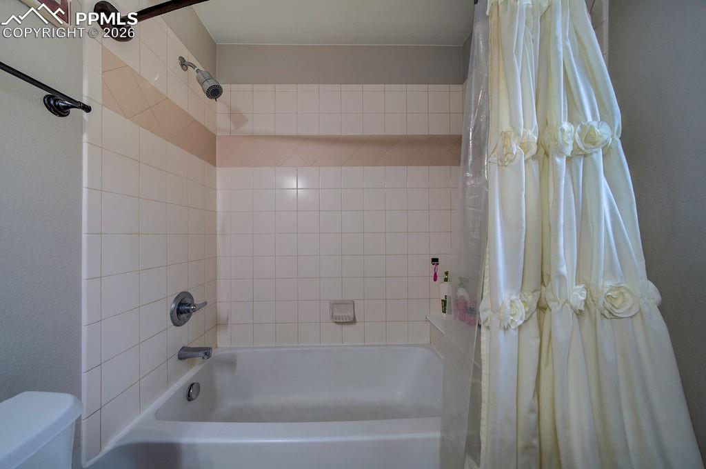 Tiled tub/shower in the Primary Bathroom.