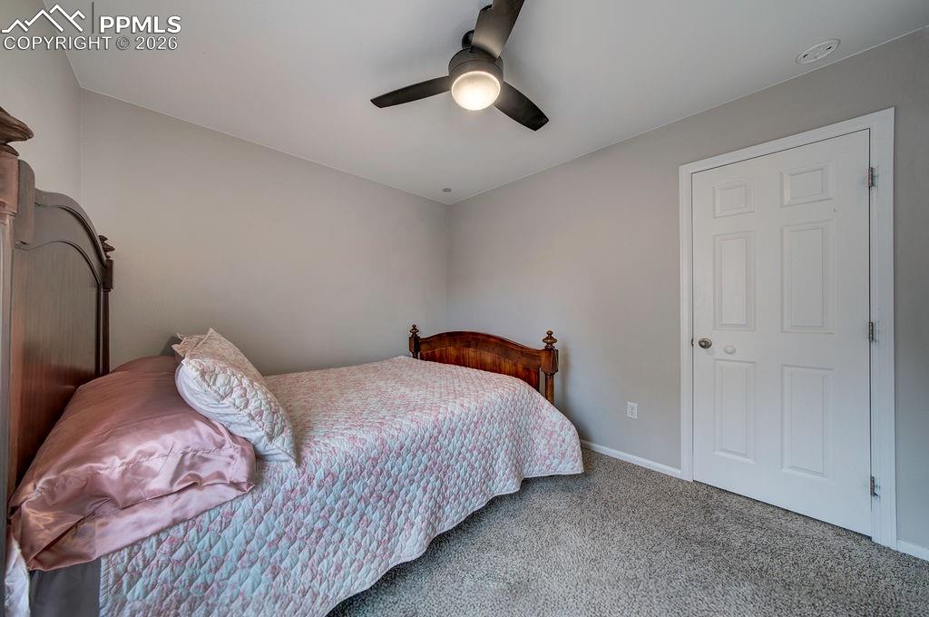 Bedroom #3 has neutral carpet, a lighted ceiling fan, and generous closet.