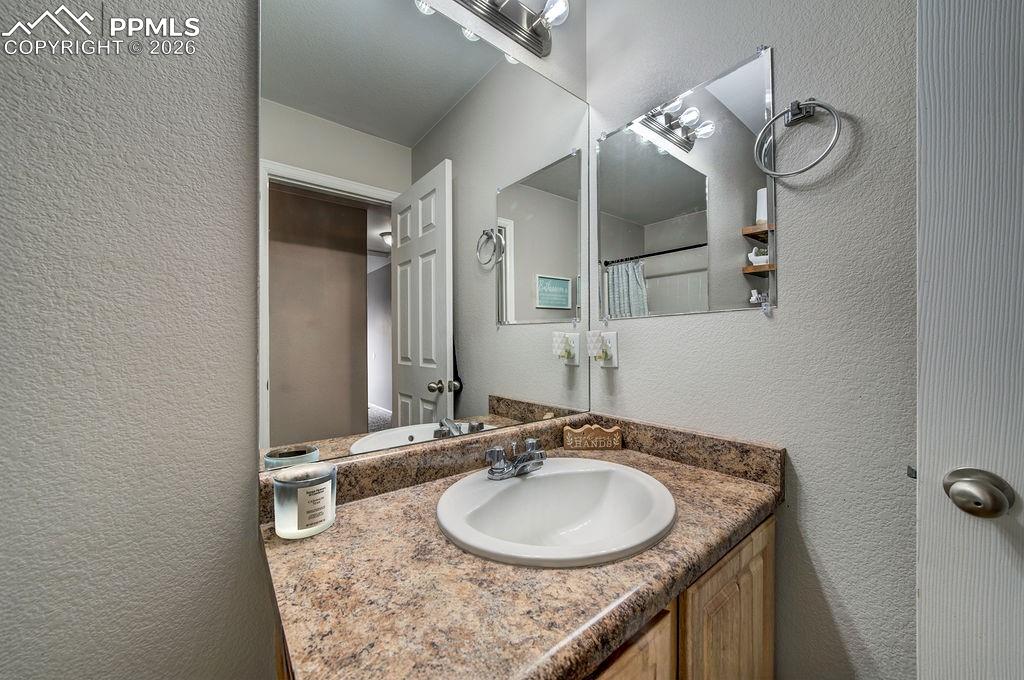 Vanity and mirror in Full Hall Bathroom.