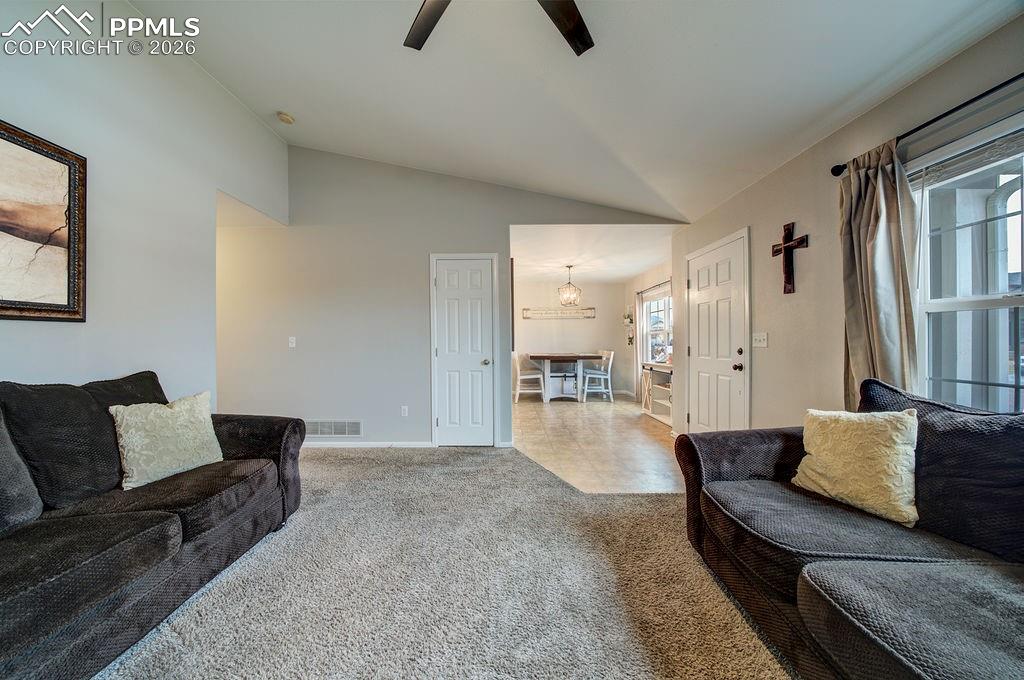 The Living Room flows seamlessly into the Dining Area and Kitchen.