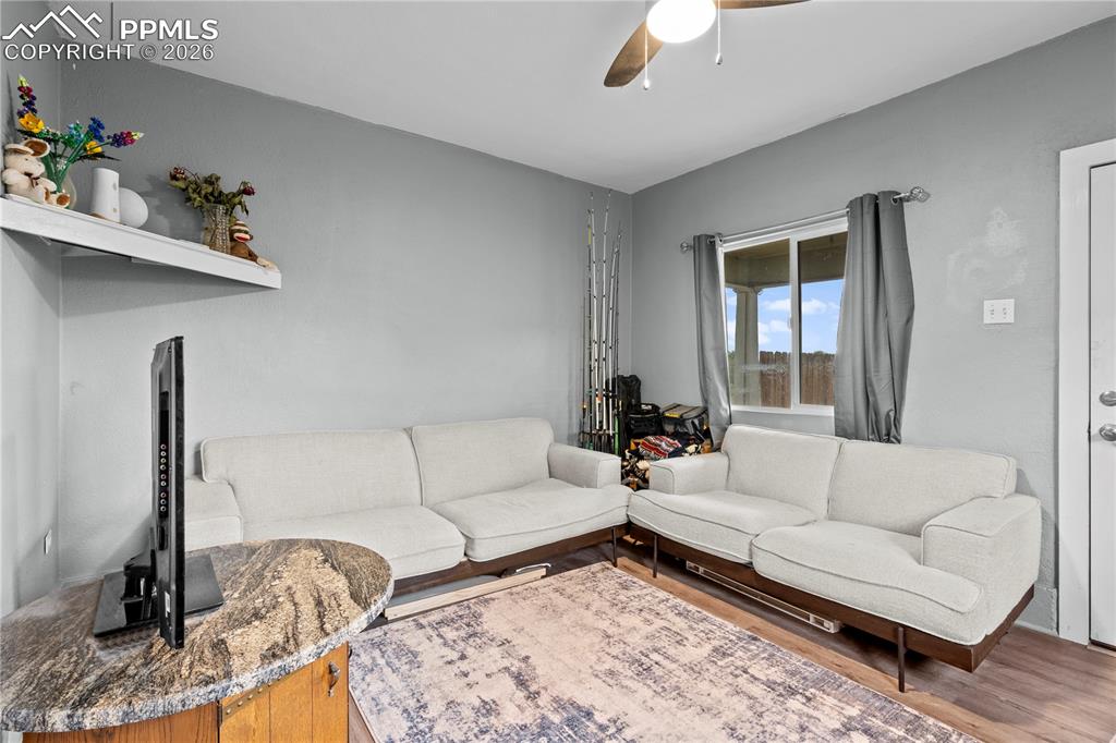 Living room with ceiling fan and wood finished floors