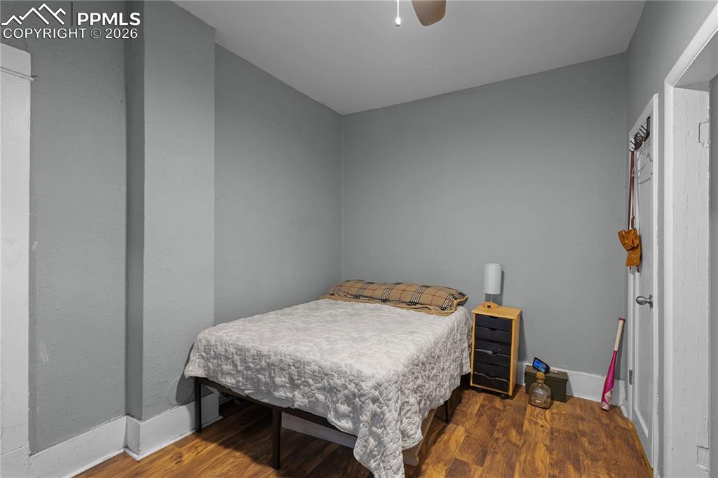 Bedroom featuring dark wood-type flooring and ceiling fan