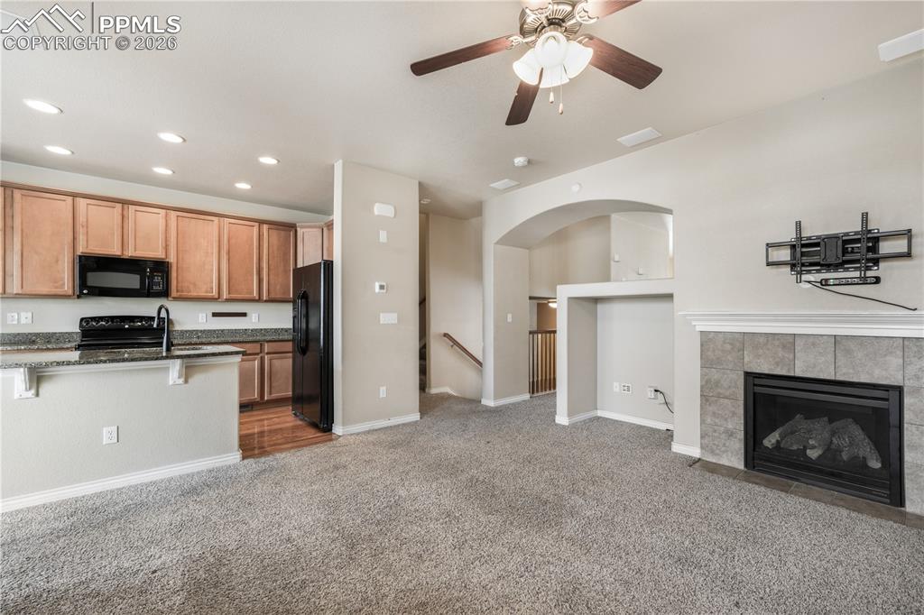 Family room with fas fireplace, access to kitchen and walk out deck
