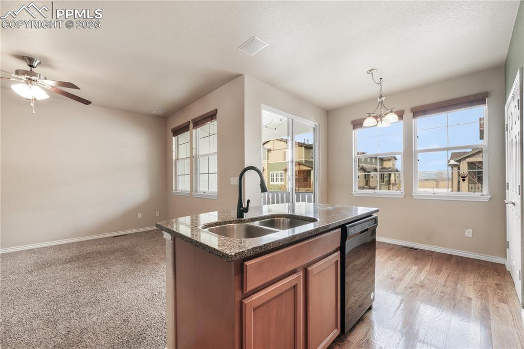 Kitchen with granite countertops, large island, additional breakfast eat in area and covered patio access