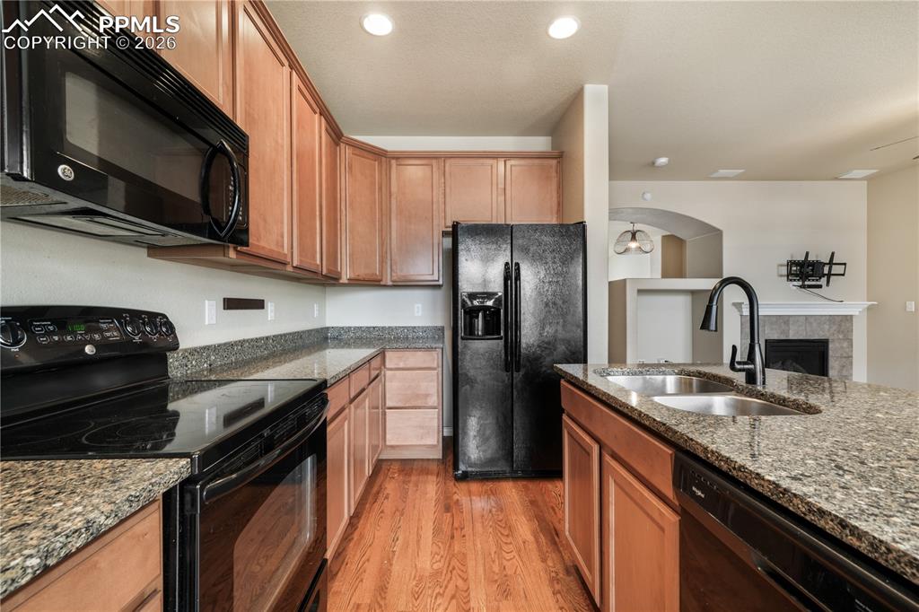 Kitchen with granite countertops, large island, additional breakfast eat in area and covered patio access