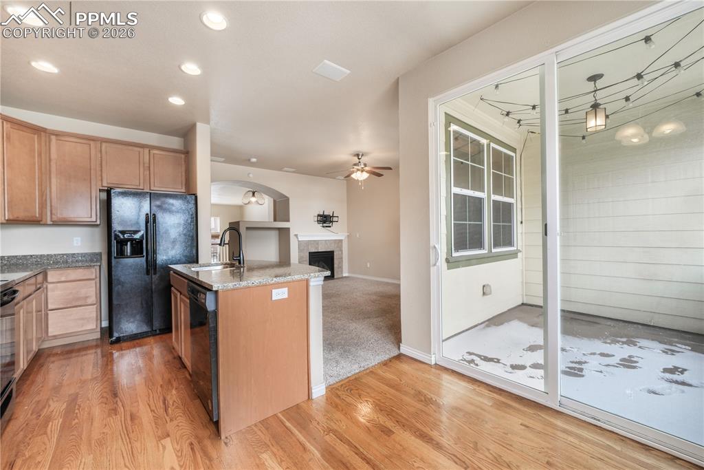 Kitchen with granite countertops, large island, additional breakfast eat in area and covered patio access