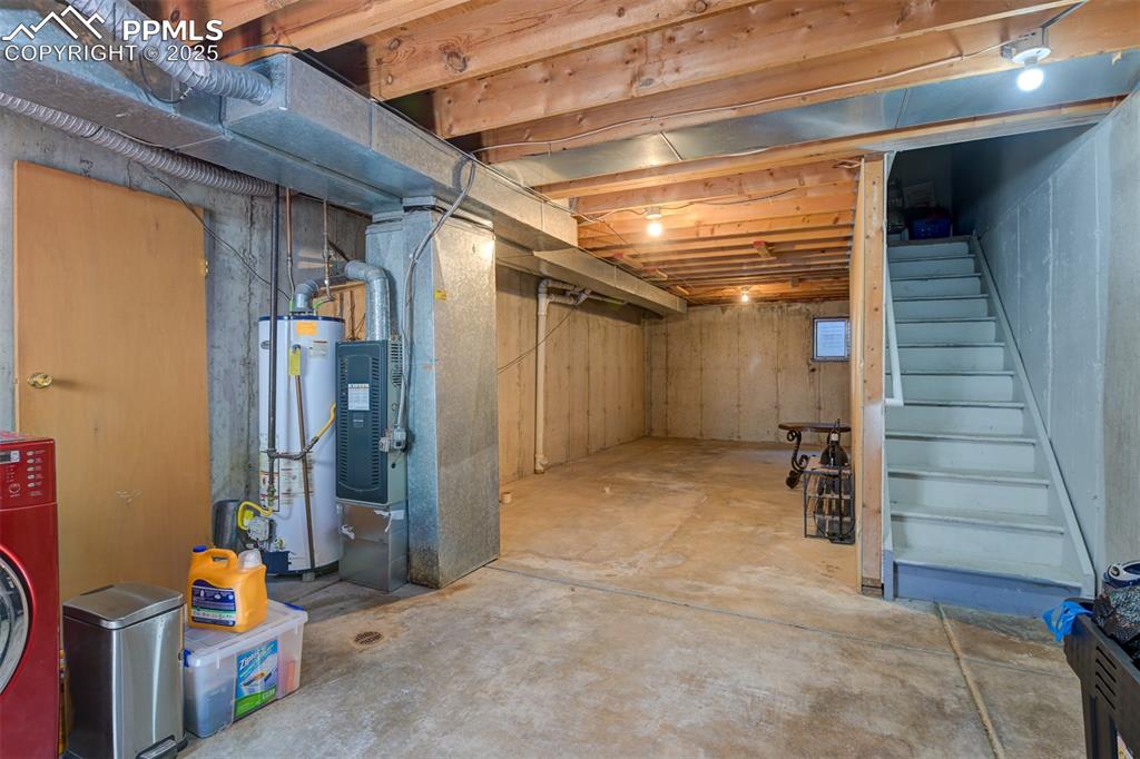 Laundry area and unfinished basement. Perfect for storage or finish and add additional living space.